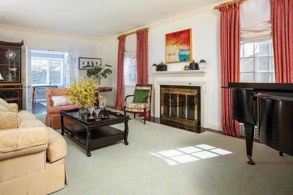 101 Blake Road Brookline, MA 02445 - Photo 13 of 28 a living room with furniture a fireplace and windows