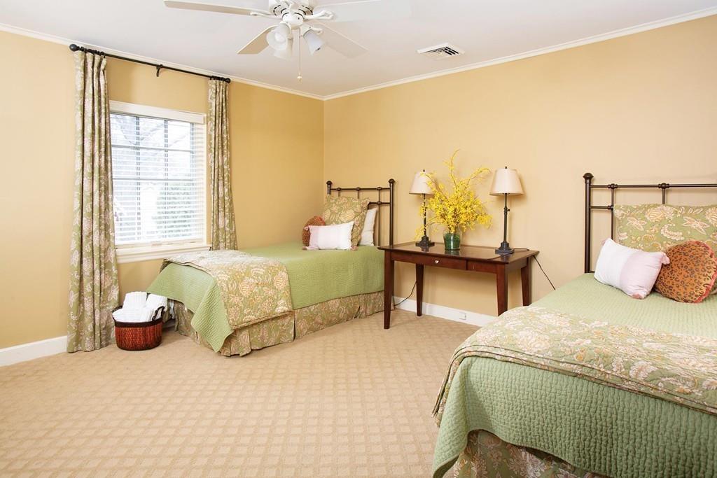 101 Blake Road Brookline, MA 02445 - Photo 20 of 28 a bedroom with a bed and a chandelier