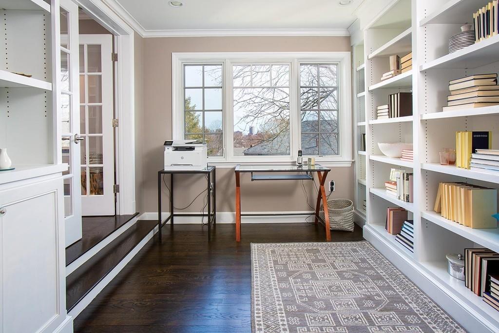 101 Blake Road Brookline, MA 02445 - Photo 7 of 28 a living room with furniture a rug and a book shelf