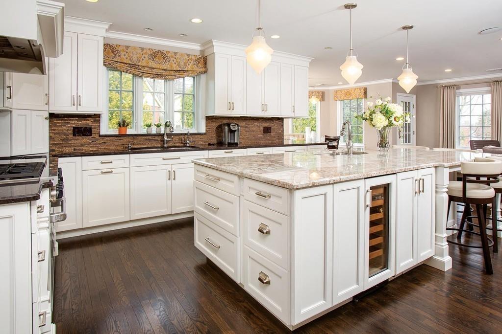 101 Blake Road Brookline, MA 02445 - Photo 8 of 28 a kitchen with kitchen island granite countertop a sink a counter space appliances and a window
