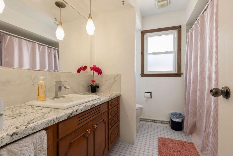 4893 Braewild Road Rockford, IL 61107 - Photo 11 of 21 a bathroom with a granite countertop sink a toilet and a shower