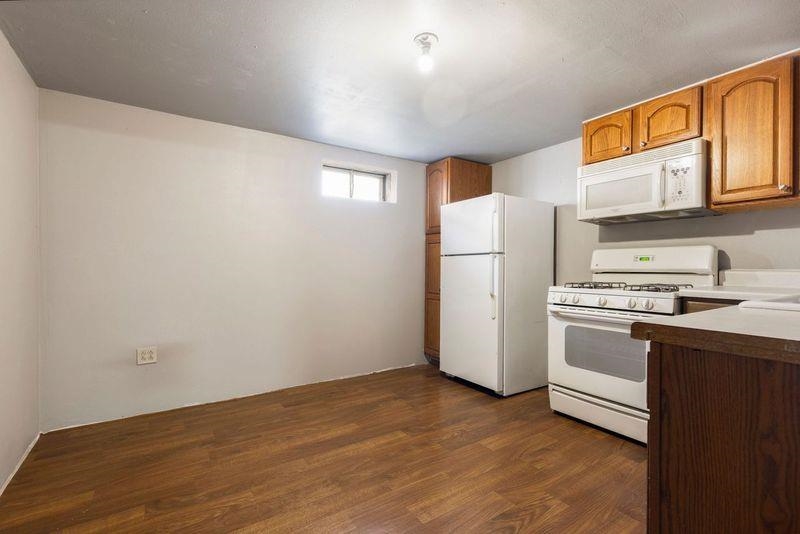 4893 Braewild Road Rockford, IL 61107 - Photo 14 of 21 a kitchen with a refrigerator sink stove and cabinets