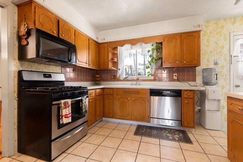 4893 Braewild Road Rockford, IL 61107 - Photo 4 of 21 a kitchen with stainless steel appliances a sink stove and microwave