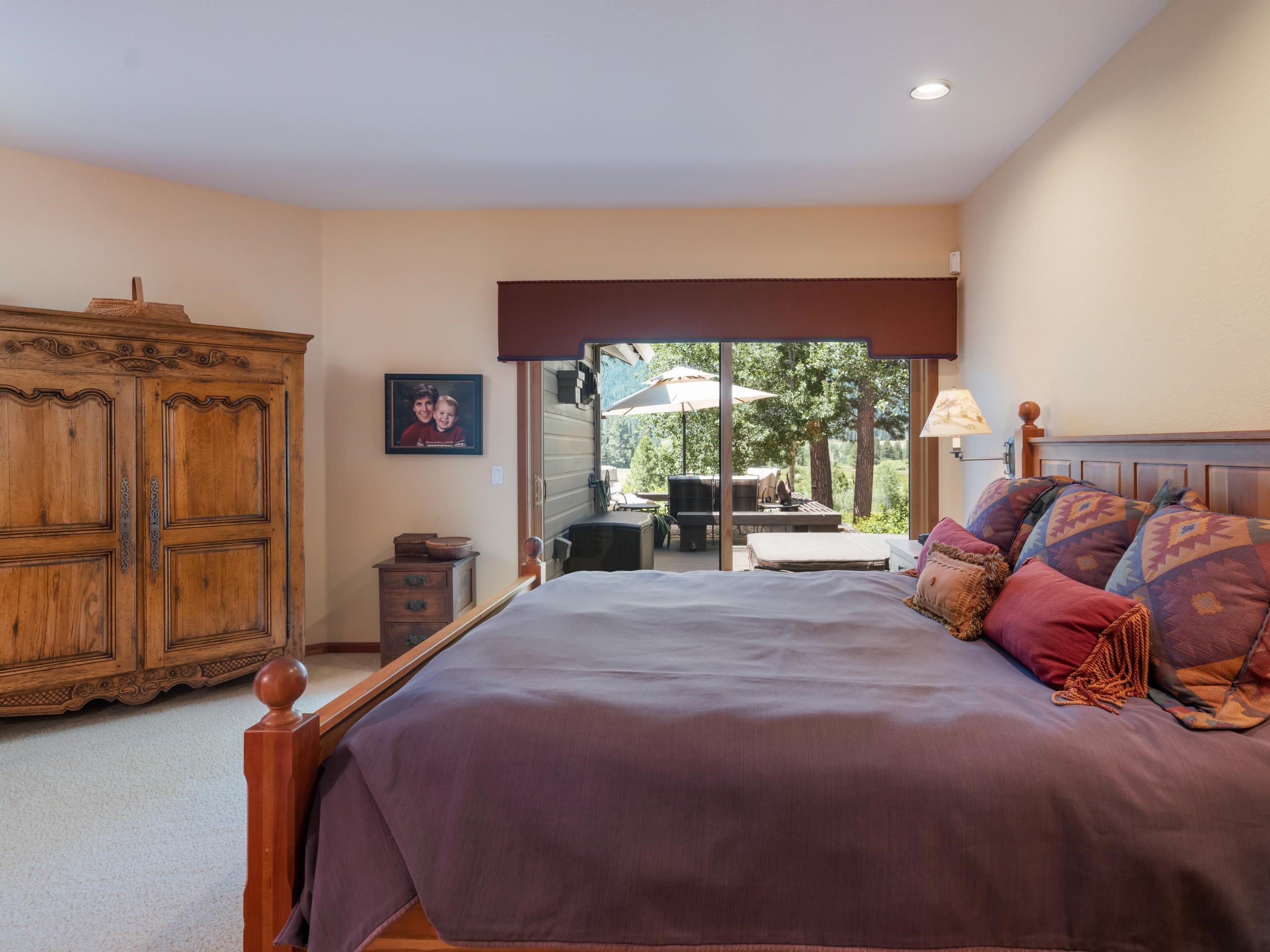 134 Quail View Circle Clio, CA 96106 - Photo 18 of 49 a bedroom with a large bed and a large window