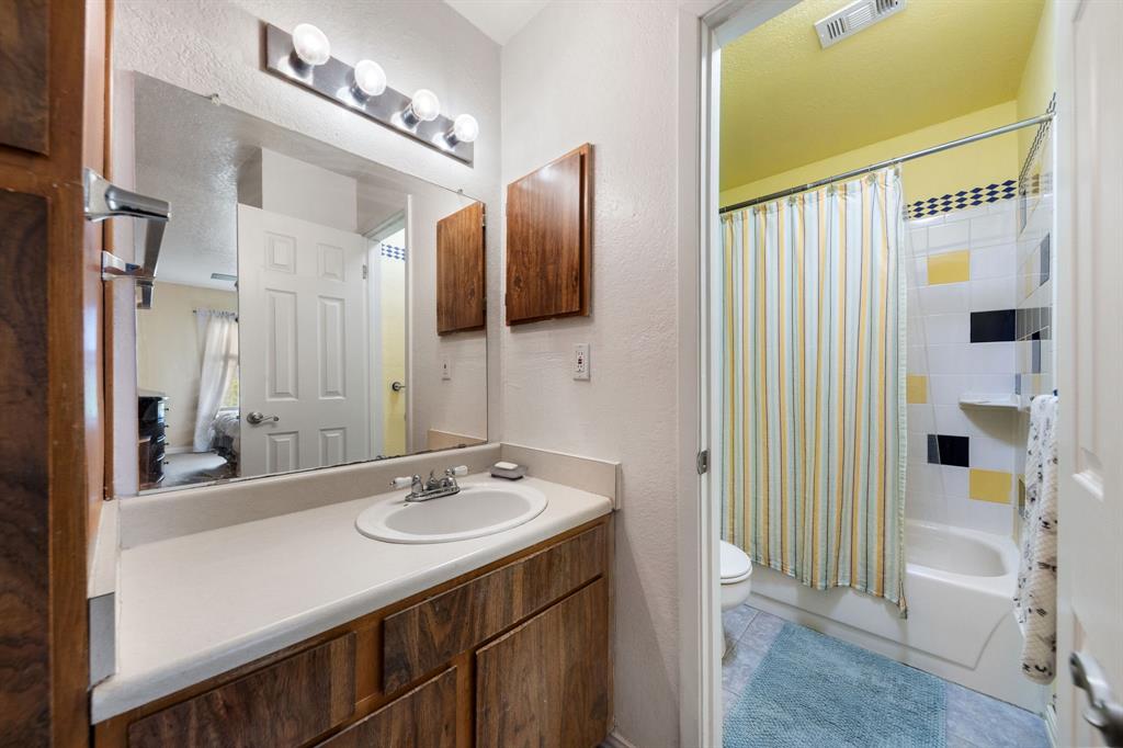 2240 Tarpley Road, Unit 411 Carrollton, TX 75006 - Photo 13 of 28 a bathroom with a sink double vanity and a mirror