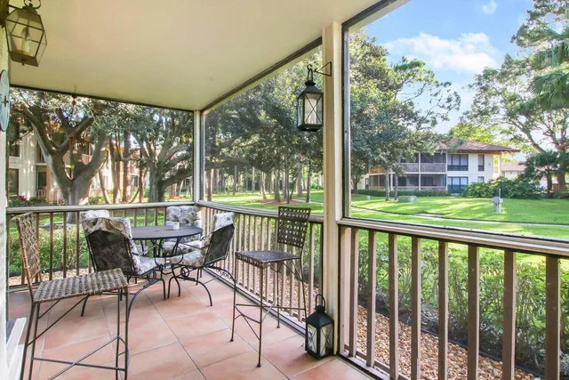 a view of a chairs and table in patio with a yard