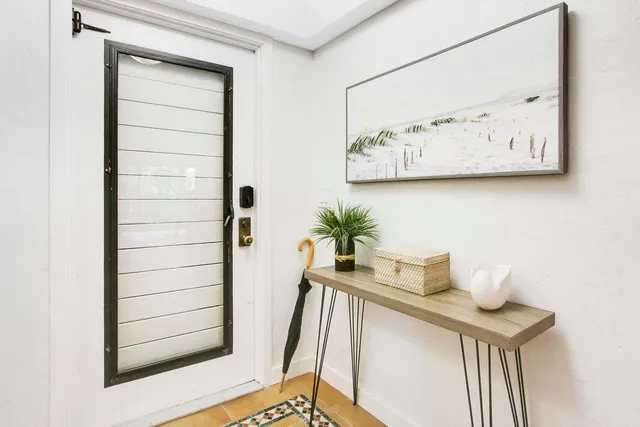 a table with a vase and flowers on it