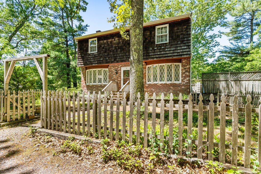5 Hazelwood Drive Hingham, MA 02043 - Photo 3 of 12 a front view of a house with a garden