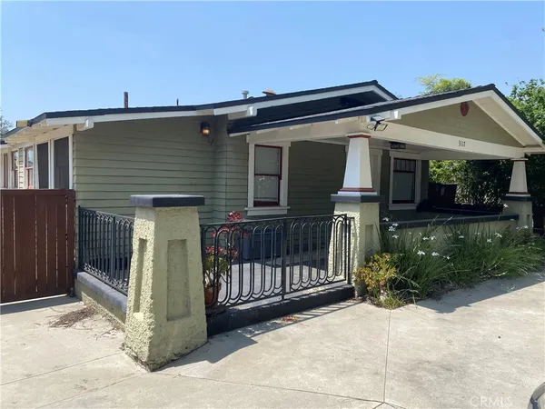 a view of house with outdoor space and porch