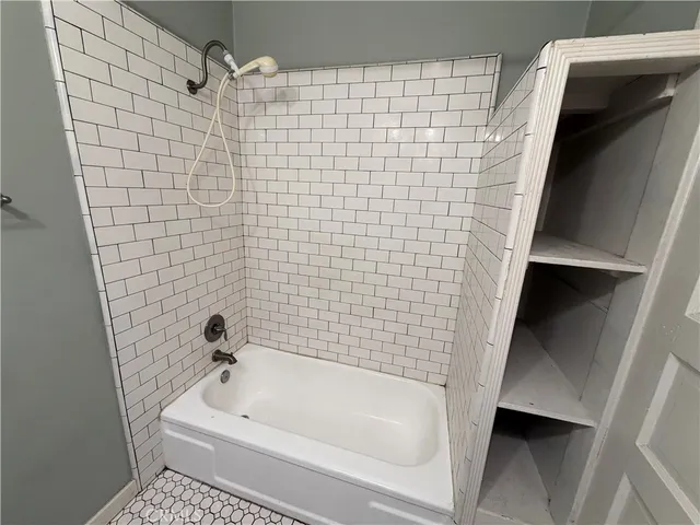 a bathroom with a bathtub and a shower
