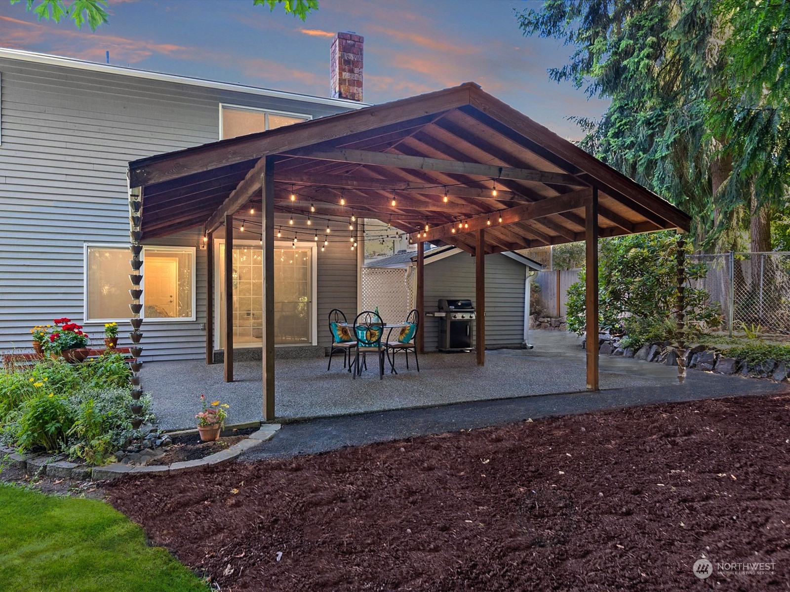 19124 27th Drive Southeast Bothell, WA 98012 - Photo 33 of 35 a view of a patio with table and chairs under an umbrella
