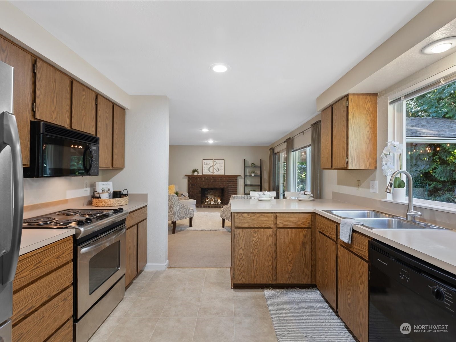 19124 27th Drive Southeast Bothell, WA 98012 - Photo 9 of 35 a kitchen with stainless steel appliances a sink stove and microwave