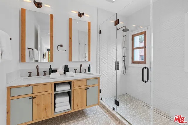 a bathroom with a shower sink and mirror