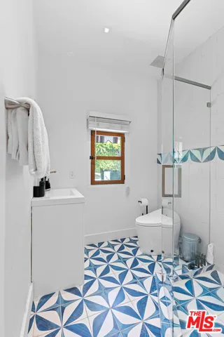 a bathroom with a sink a mirror and a shower