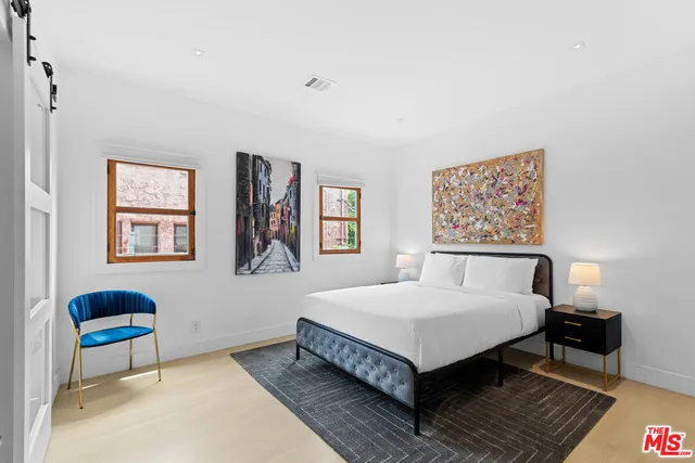 a bedroom with a bed and a table in it