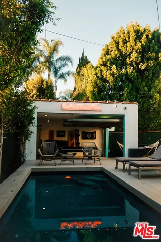 a view of house with outdoor space and swimming pool