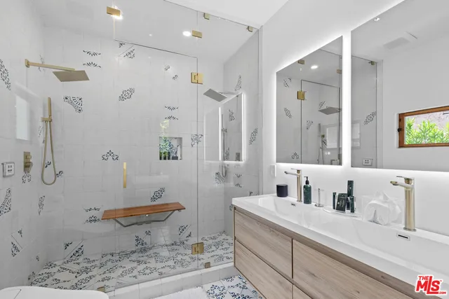 a spacious bathroom with a granite countertop sink a toilet and shower