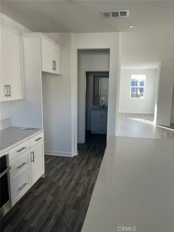 a view of a kitchen from the hallway