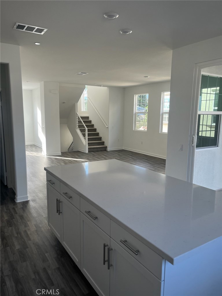 8315 Gabrielino Court Rancho Cucamonga, CA 91730 - Photo 12 of 27 an empty room with wooden floor and windows