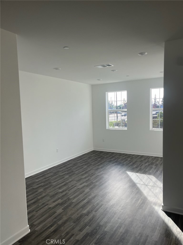 8315 Gabrielino Court Rancho Cucamonga, CA 91730 - Photo 13 of 27 an empty room with wooden floor and windows