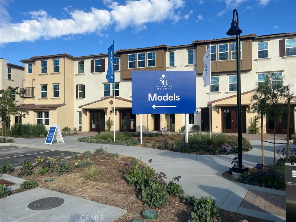 8315 Gabrielino Court Rancho Cucamonga, CA 91730 - Photo 2 of 27 a front view of a residential apartment building with a yard