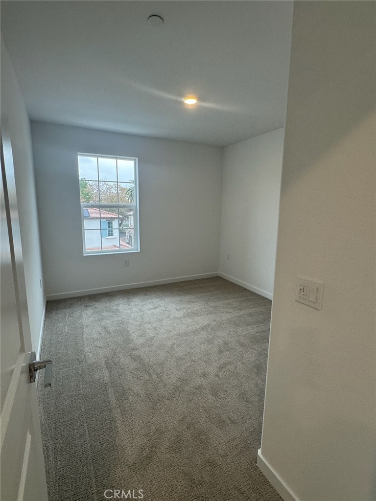 8315 Gabrielino Court Rancho Cucamonga, CA 91730 - Photo 24 of 27 an empty room with a empty space and windows