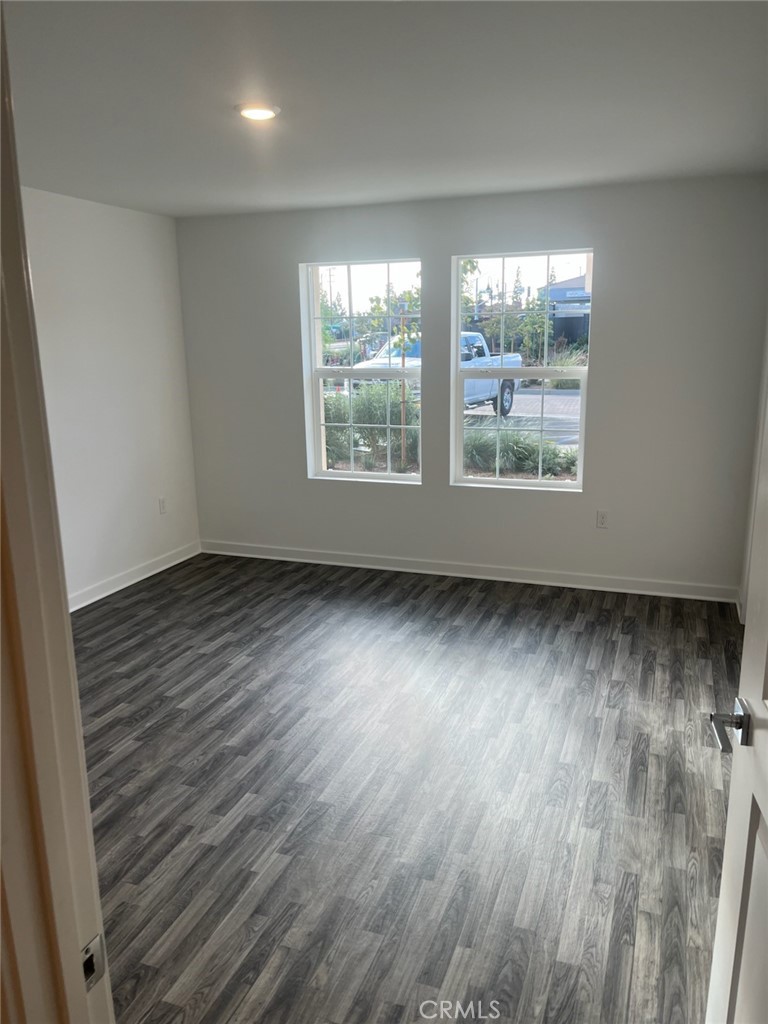 8315 Gabrielino Court Rancho Cucamonga, CA 91730 - Photo 8 of 27 an empty room with wooden floor and windows