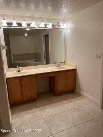 a bathroom with a sink vanity and mirror