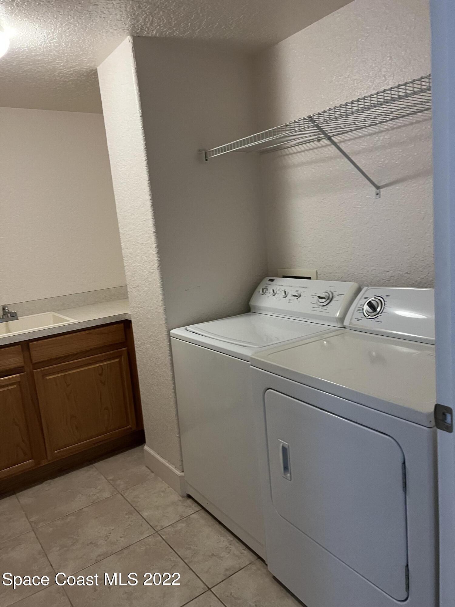817 Mystic Drive, Unit B410 Cape Canaveral, FL 32920 - Photo 17 of 28 a utility room with dryer and washer