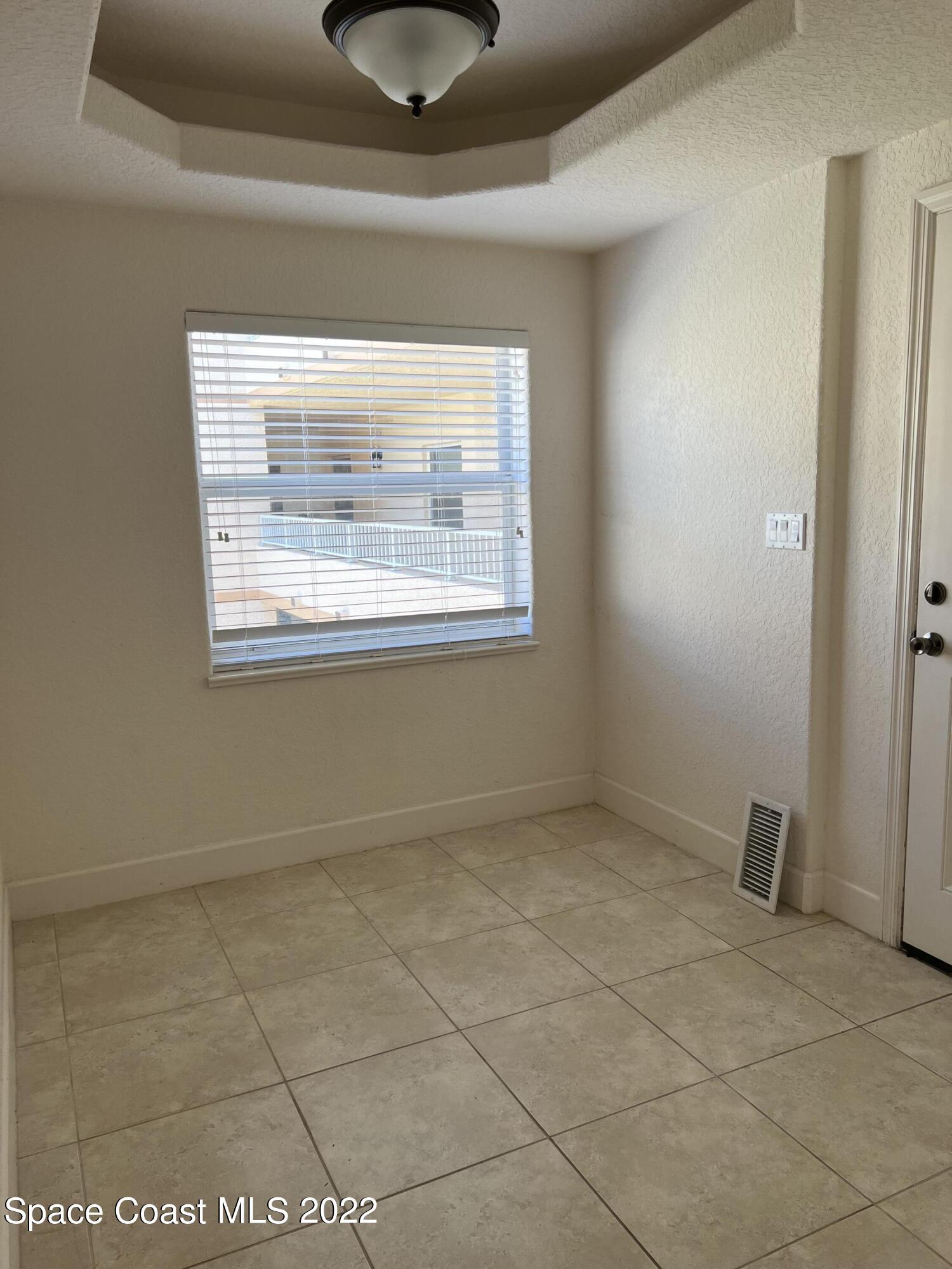 817 Mystic Drive, Unit B410 Cape Canaveral, FL 32920 - Photo 19 of 28 a view of an empty room with a window