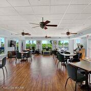 817 Mystic Drive, Unit B410 Cape Canaveral, FL 32920 - Photo 23 of 28 a view of a dining room with furniture window and wooden floor