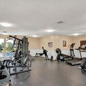 817 Mystic Drive, Unit B410 Cape Canaveral, FL 32920 - Photo 24 of 28 a view of a room with gym equipment