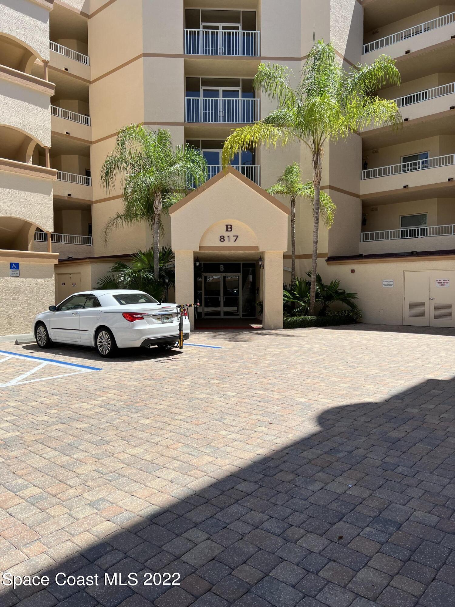 817 Mystic Drive, Unit B410 Cape Canaveral, FL 32920 - Photo 3 of 28 a car parked in front of a building
