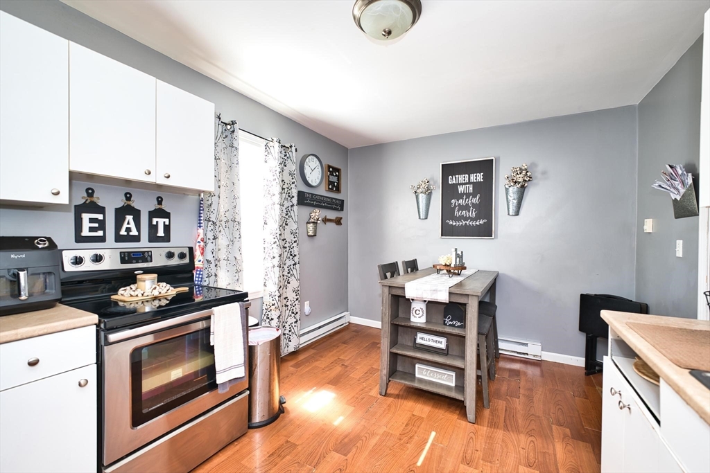 232 Alden Street Fall River, MA 02723 - Photo 28 of 34 a kitchen with a wooden floor and white appliances