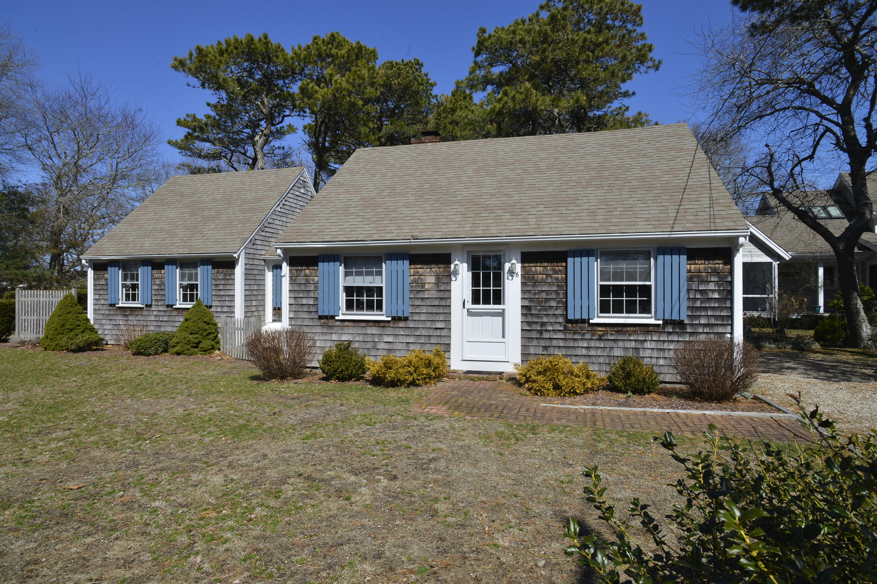 26 Lower County Road Dennis Port, MA 02639 - Photo 1 of 32 a front view of a house with a yard