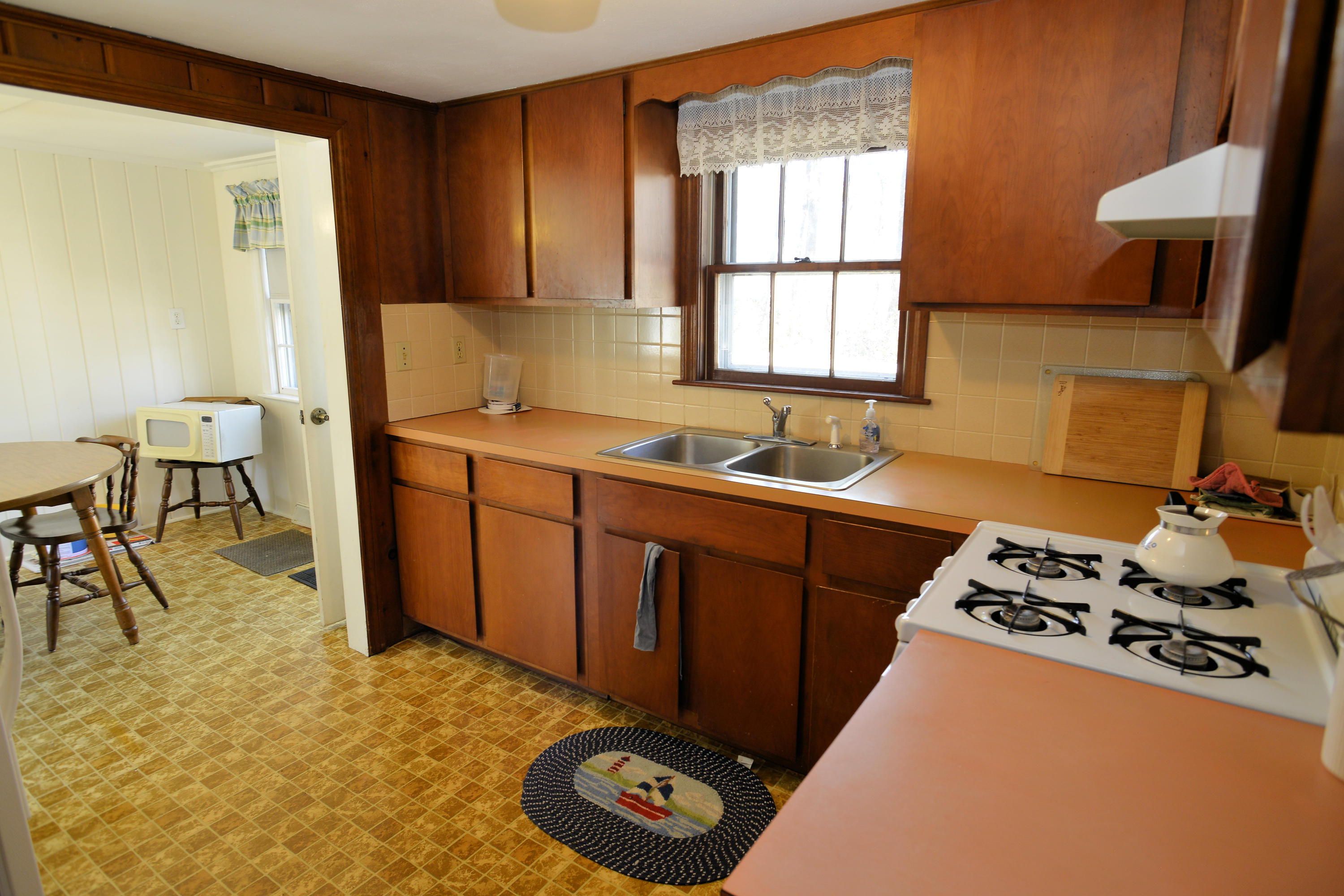 26 Lower County Road Dennis Port, MA 02639 - Photo 16 of 32 a kitchen with stainless steel appliances a sink a stove and a refrigerator