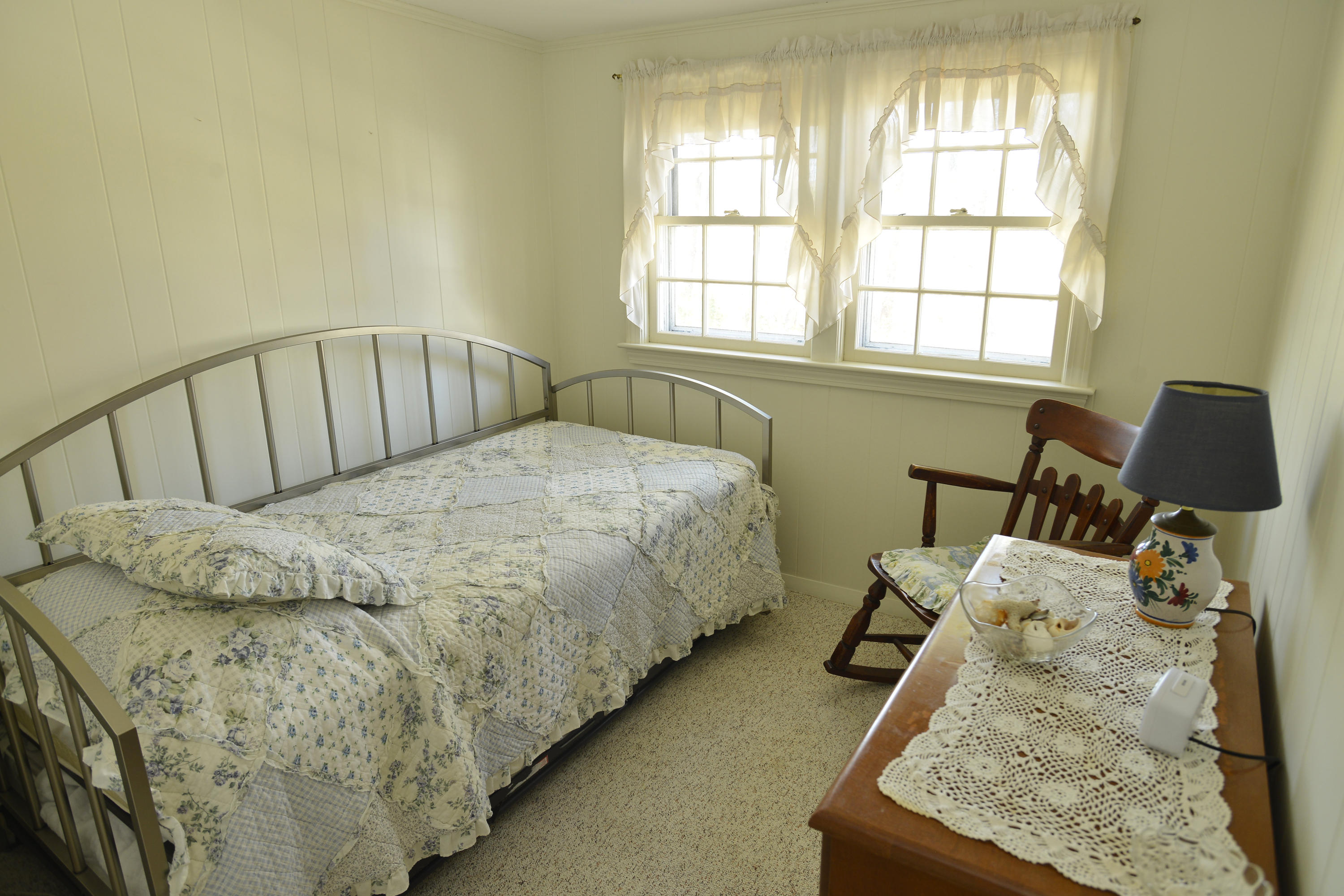 26 Lower County Road Dennis Port, MA 02639 - Photo 25 of 32 a bed sitting in a bedroom next to a window