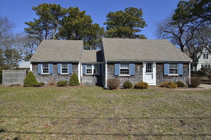 26 Lower County Road Dennis Port, MA 02639 - Photo 4 of 32 a front view of a house with a garden