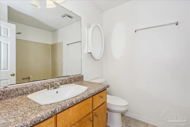 a view of a tall building next to a yard