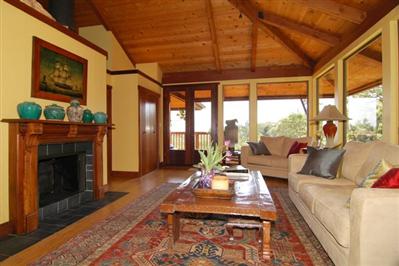 195 Crest Road Novato, CA 94945 - Photo 3 of 12 a living room with furniture a fireplace and a floor to ceiling window