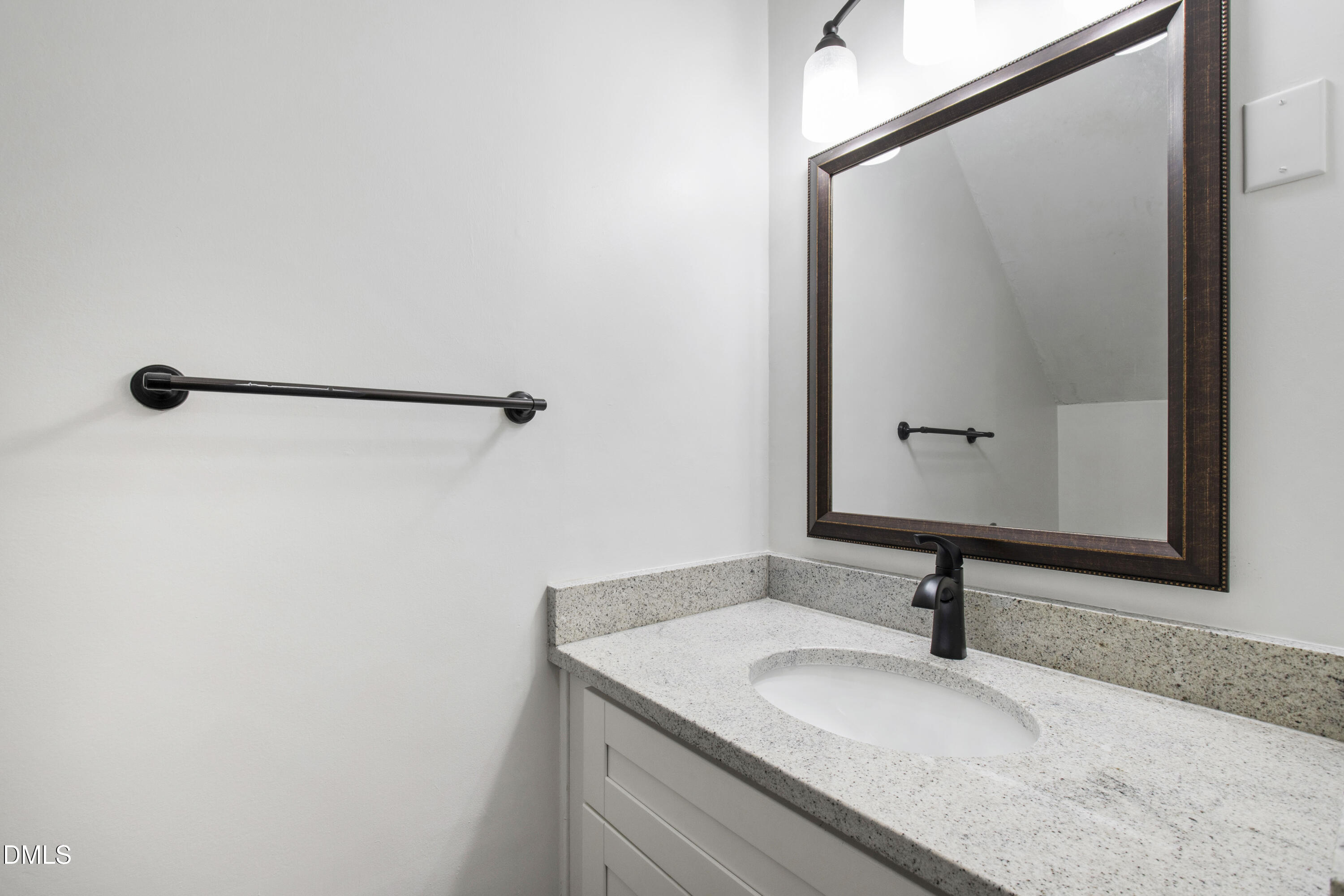 2824 Wayland Drive Raleigh, NC 27608 - Photo 18 of 31 a bathroom with a granite countertop sink and a mirror