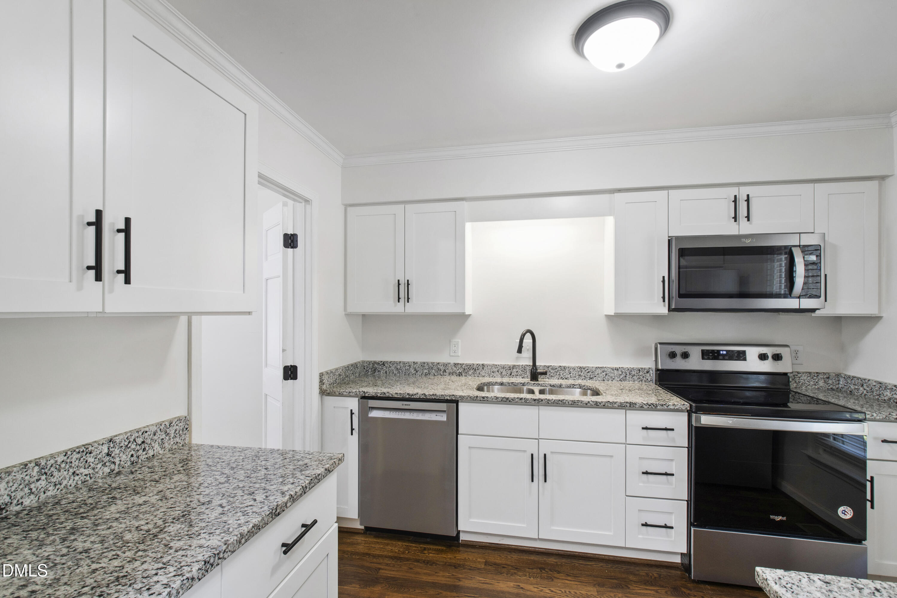 2824 Wayland Drive Raleigh, NC 27608 - Photo 7 of 31 a kitchen with stainless steel appliances granite countertop a stove a sink and a microwave