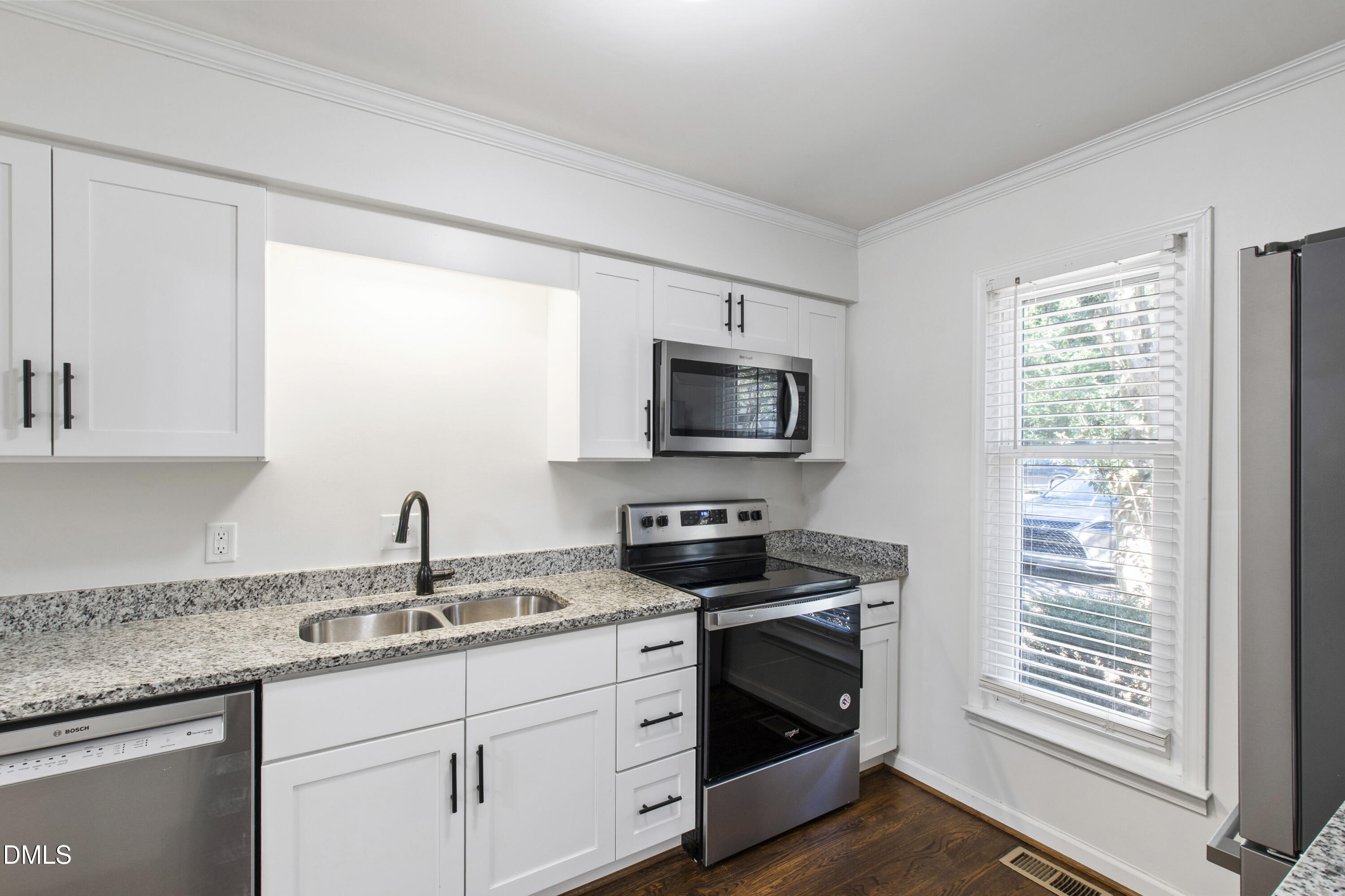 2824 Wayland Drive Raleigh, NC 27608 - Photo 8 of 31 a kitchen with stainless steel appliances granite countertop a sink stove and microwave