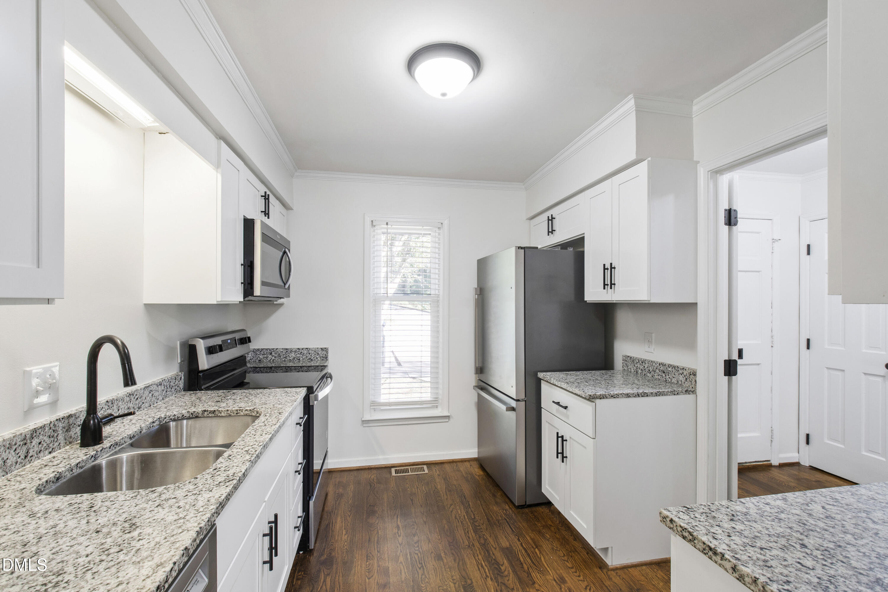 2824 Wayland Drive Raleigh, NC 27608 - Photo 9 of 31 a kitchen with stainless steel appliances granite countertop a sink stove and refrigerator