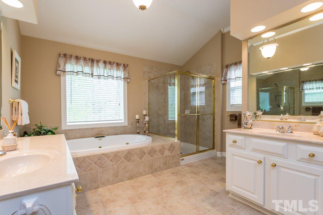7260 Summit Waters Lane Raleigh, NC 27613 - Photo 15 of 23 a bathroom with a tub sink and mirror