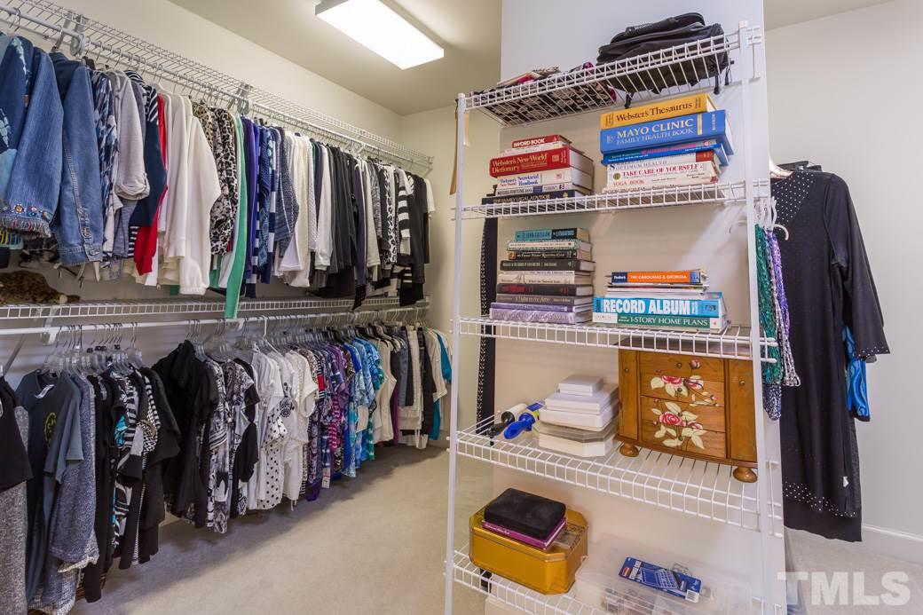 7260 Summit Waters Lane Raleigh, NC 27613 - Photo 16 of 23 a view of walk in closet with clothes and shoes