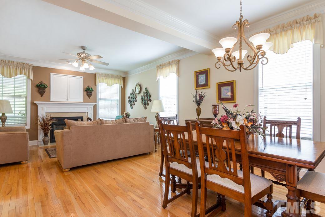 7260 Summit Waters Lane Raleigh, NC 27613 - Photo 5 of 23 a living room with furniture dining table and a chandelier
