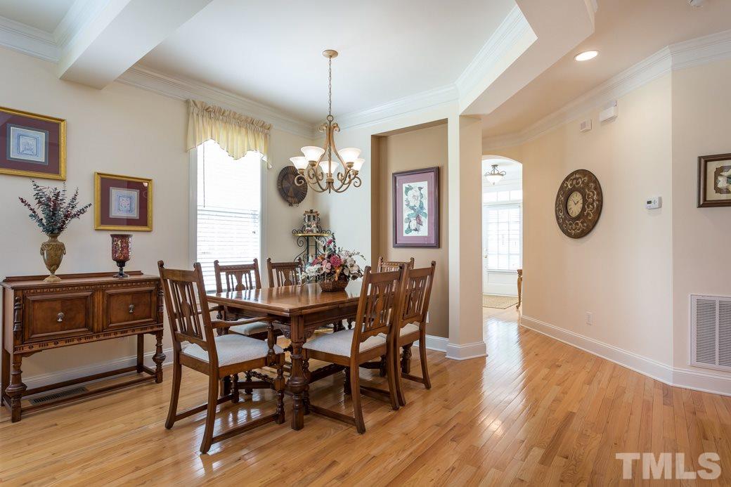 7260 Summit Waters Lane Raleigh, NC 27613 - Photo 6 of 23 a view of a dining room with furniture window and wooden floor