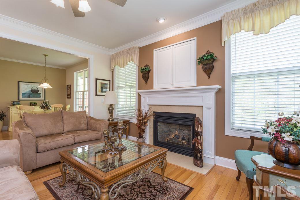 7260 Summit Waters Lane Raleigh, NC 27613 - Photo 7 of 23 a living room with furniture and a fireplace