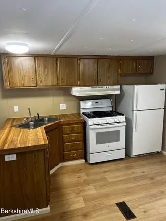 a kitchen with a stove and a refrigerator